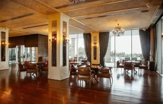 restaurant-hall-with-leather-armchairs-french-windows_11zon